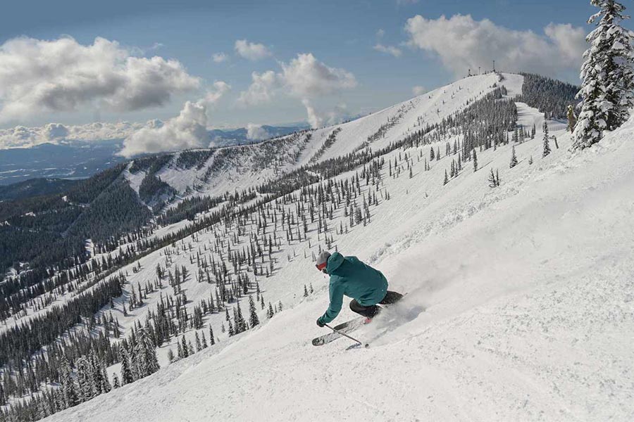 Schweitzer snow covered mountain with skier skiing