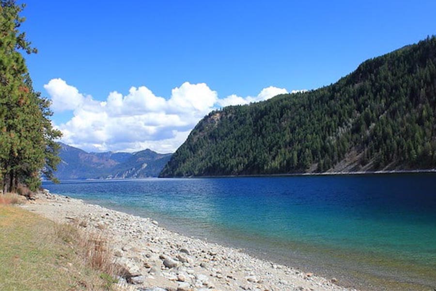 Farragut State Park secluded riverbank with mountains and clouds in the background